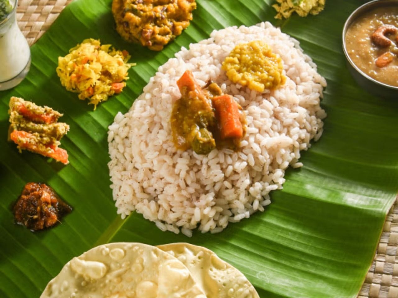 Traditional Malnad meals on a banana leaf — rice, palya, sambar, pickle and papad