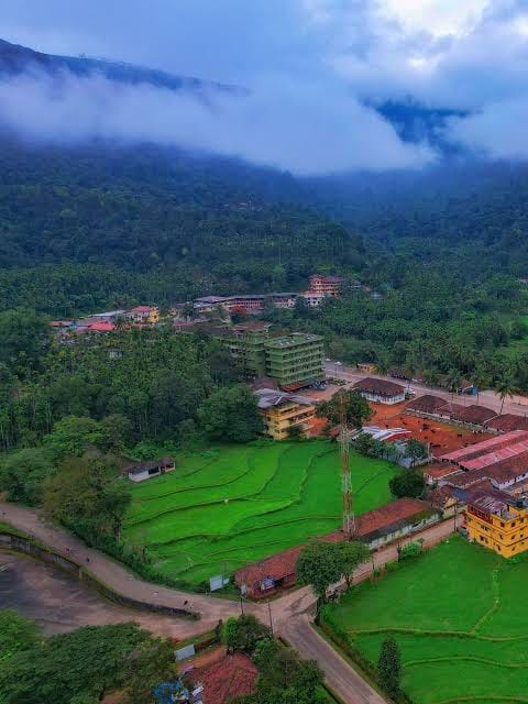 Aerial view of Horanadu town surrounded by misty Malnad hills