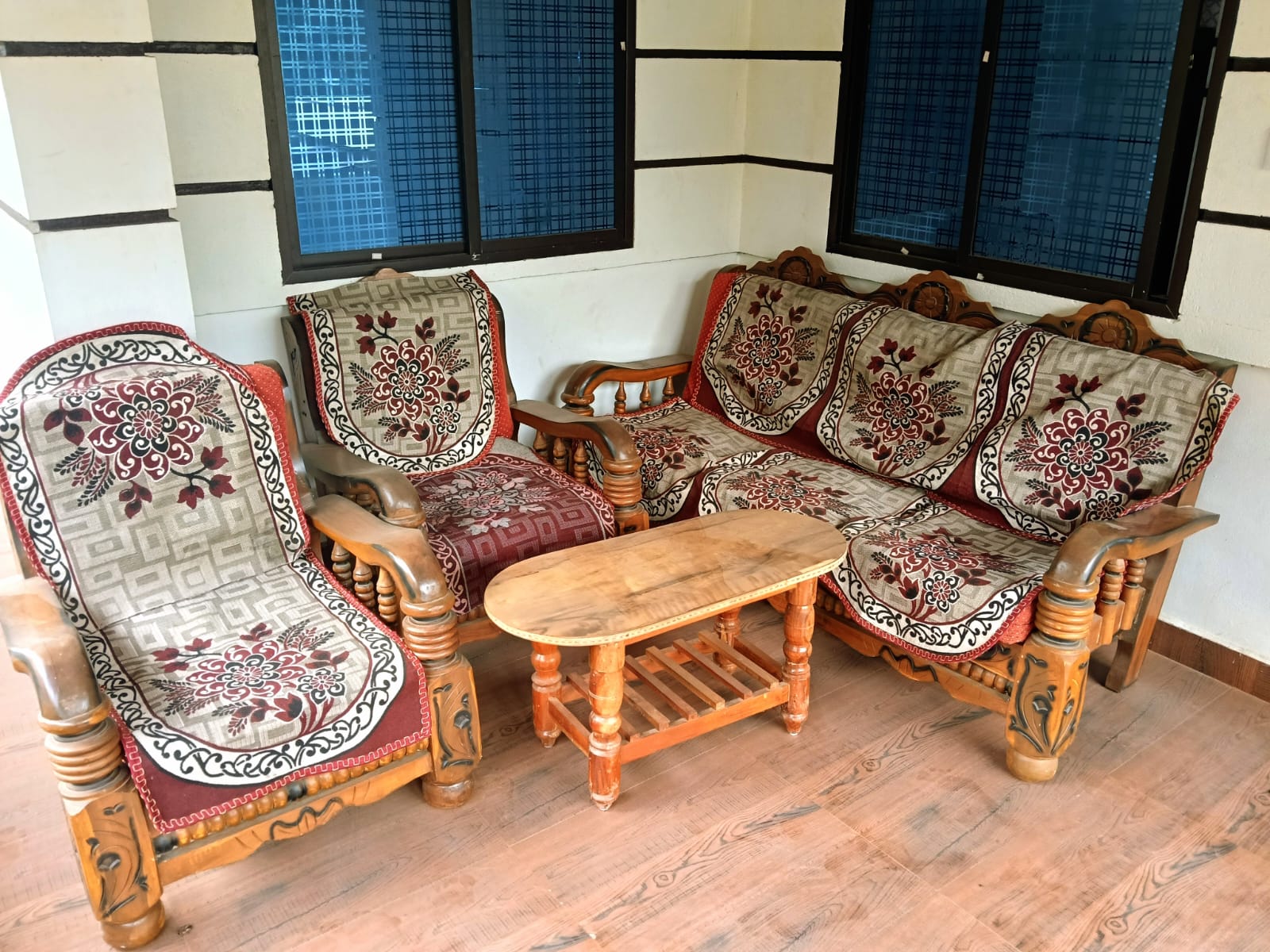 Comfortable sit-out with wooden sofa set at Bhavani Homestay, Horanadu